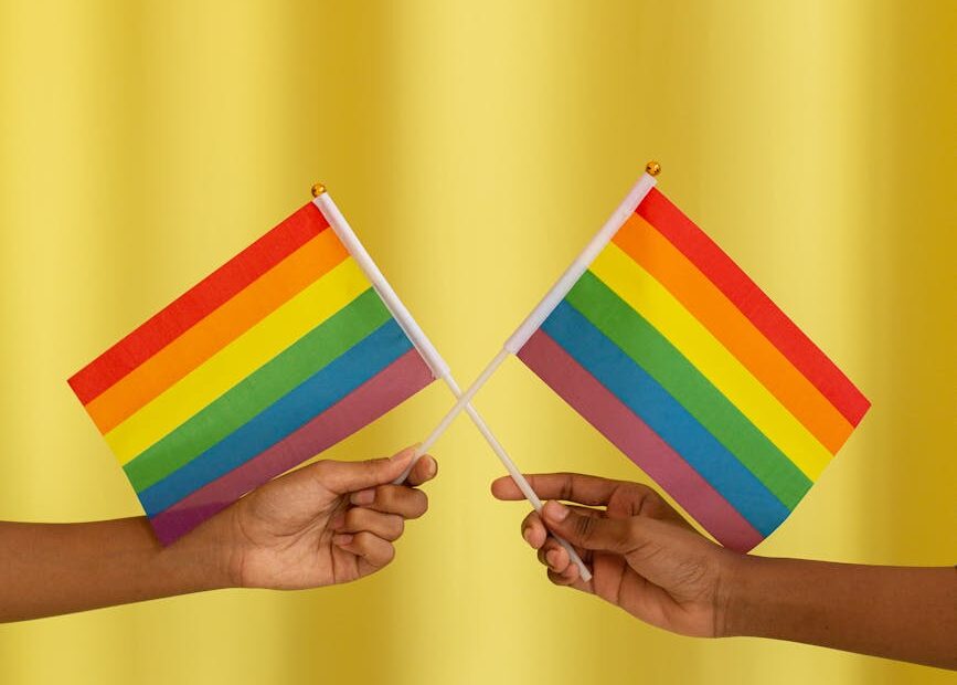 two people holding pride flag